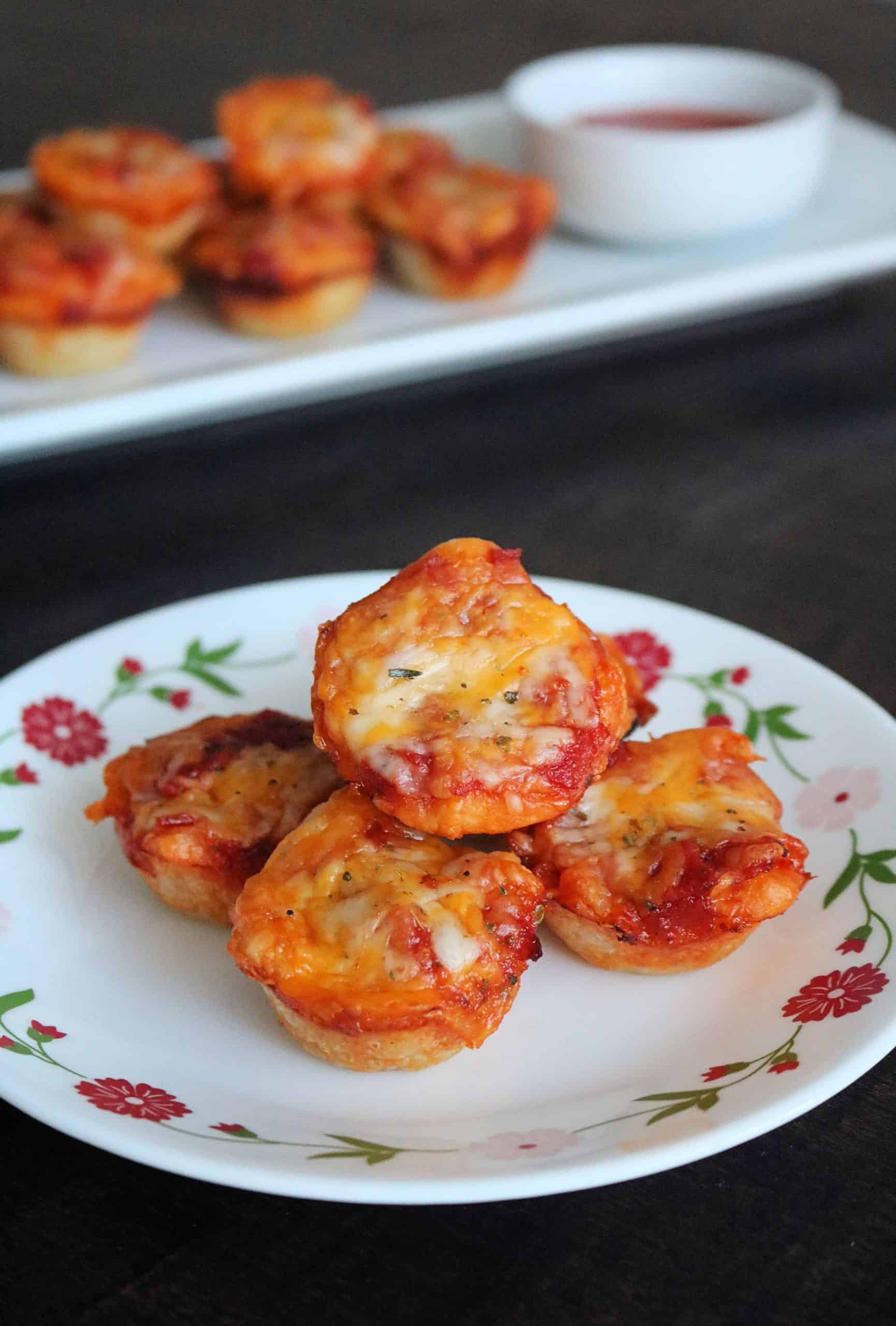 These Easy Mini Pepperoni Pizza Muffins are made with refrigerated pizza dough, pepperoni, cheese, pizza sauce, and Italian seasoning. Make these delicious pizza muffins for dinner in less than 20 minutes! #pizza #pizzarecipe #easydinner #appetizer