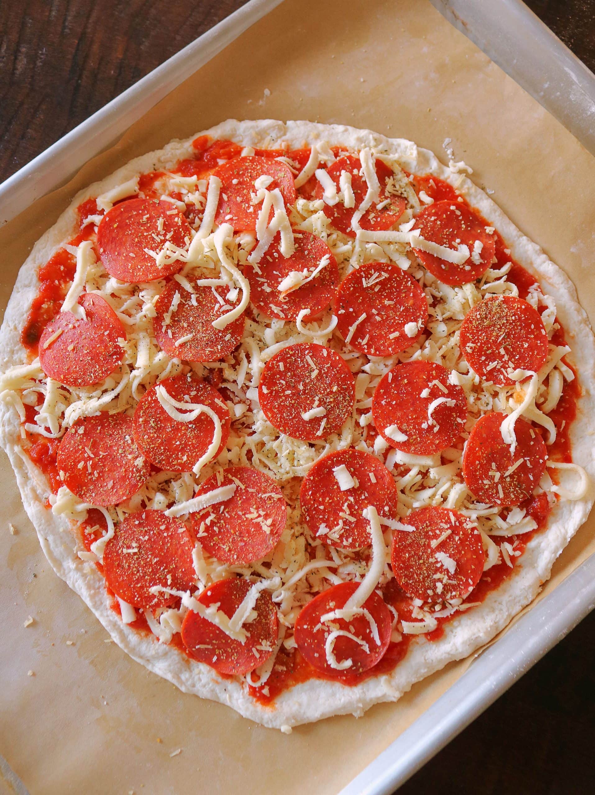 This Easy 2 Ingredient Pizza Dough with Self Rising Flour makes the most delicious pizza crust with no yeast or rising time required! Try my simple and healthy Weight Watchers Pizza Dough made with plain non-fat Greek yogurt and self-rising flour for your next homemade pizza night, and use it for pizza dough, cheese sticks, pretzel bites, and more! #pizzadough #pizza #weighwatchers #greekyogurtpizzadough #selfrisingdough