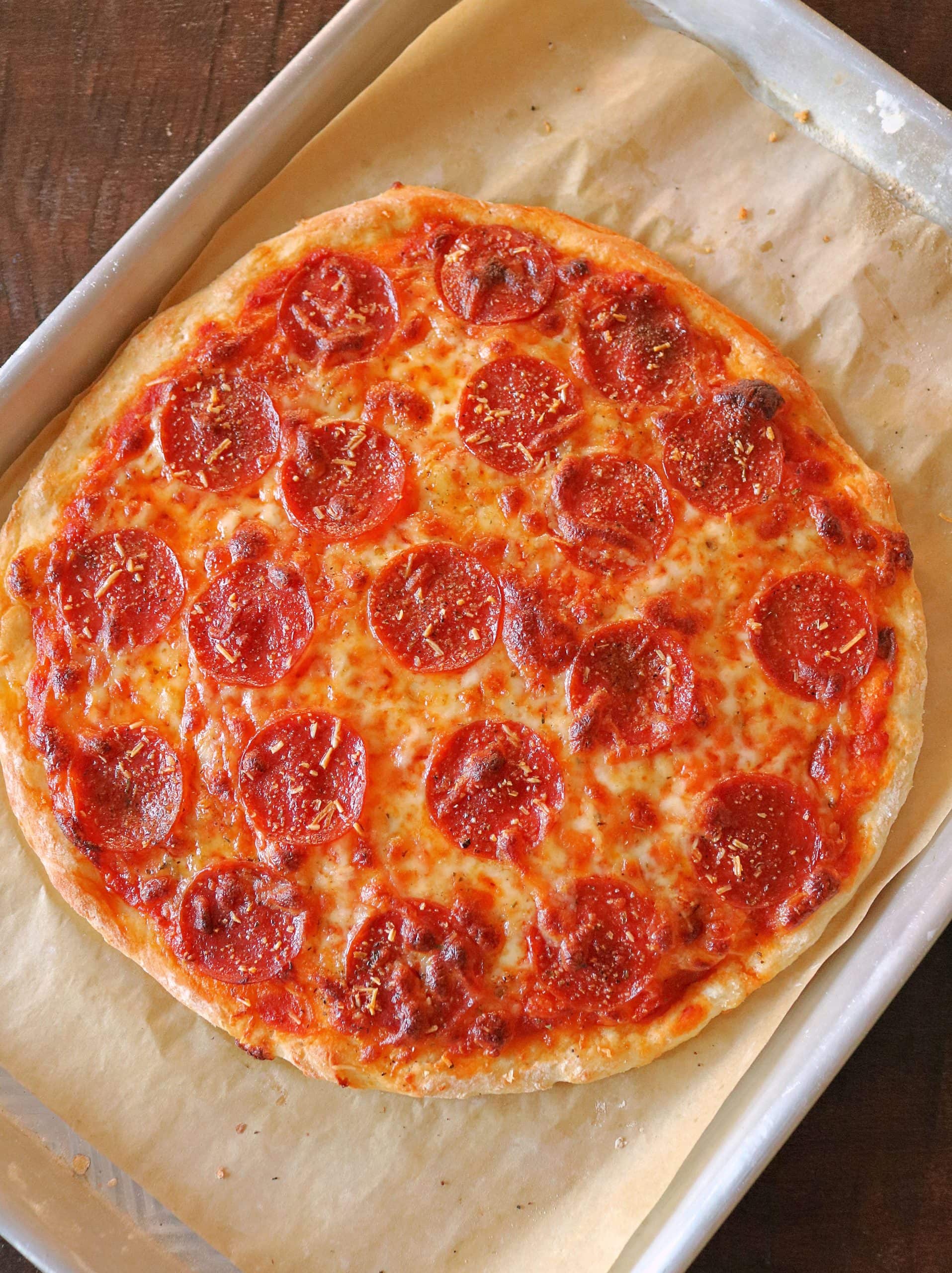 This Easy 2 Ingredient Pizza Dough with Self Rising Flour makes the most delicious pizza crust with no yeast or rising time required! Try my simple and healthy Weight Watchers Pizza Dough made with plain non-fat Greek yogurt and self-rising flour for your next homemade pizza night, and use it for pizza dough, cheese sticks, pretzel bites, and more! #pizzadough #pizza #weighwatchers #greekyogurtpizzadough #selfrisingdough
