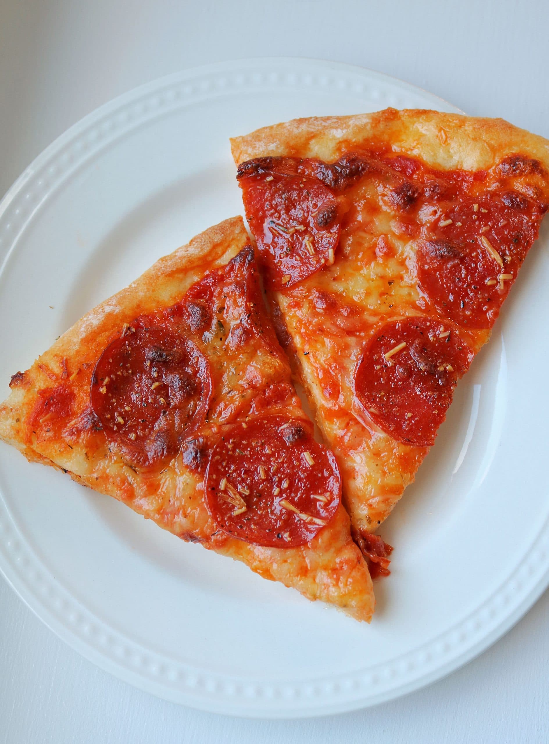 This Easy 2 Ingredient Pizza Dough with Self Rising Flour makes the most delicious pizza crust with no yeast or rising time required! Try my simple and healthy Weight Watchers Pizza Dough made with plain non-fat Greek yogurt and self-rising flour for your next homemade pizza night, and use it for pizza dough, cheese sticks, pretzel bites, and more! #pizzadough #pizza #weighwatchers #greekyogurtpizzadough #selfrisingdough
