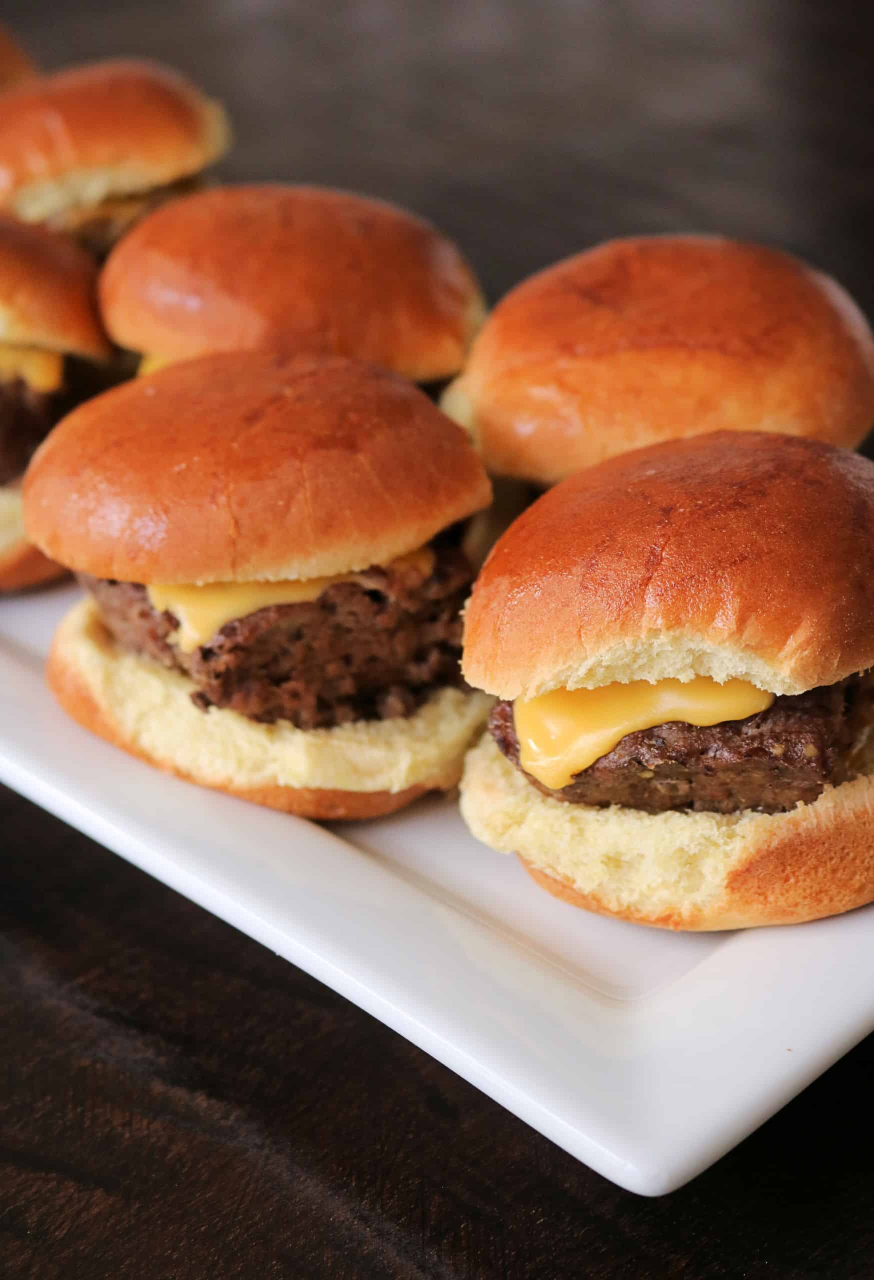 Grab some hamburger meat, dinner rolls, and cheese, and make these Delicious and Easy Cheeseburger Sliders for your next family dinner! They're juicy, flavorful, and oven baked on a sheet pan for quick and easy cheeseburgers for a crowd or party! #cheeseburgersliders #sliders #cheeseburgers #easydinner
