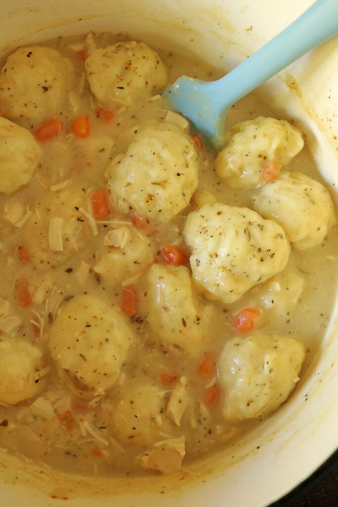 These are the best old fashioned chicken and dumplings you'll ever eat! Featuring tender rotisserie chicken, simple homemade broth, and fluffy self rising flour biscuit dumplings, this delicious and easy recipe is comfort food at its finest.