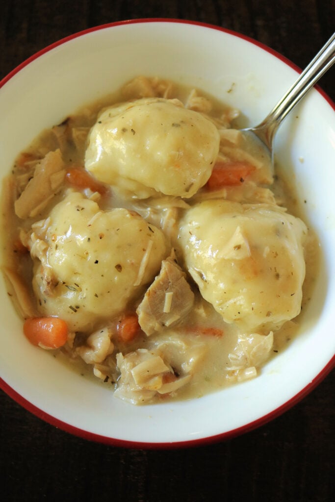 These are the best old fashioned chicken and dumplings you'll ever eat! Featuring tender rotisserie chicken, simple homemade broth, and fluffy self rising flour biscuit dumplings, this delicious and easy recipe is comfort food at its finest.